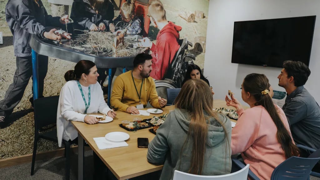 colleagues-sat-around-a-desk-enjoying-a-buffet-supplied-by-corporate-catering-experts colleagues-sat-around-a-desk-enjoying-a-buffet-supplied-by-corporate-catering-experts